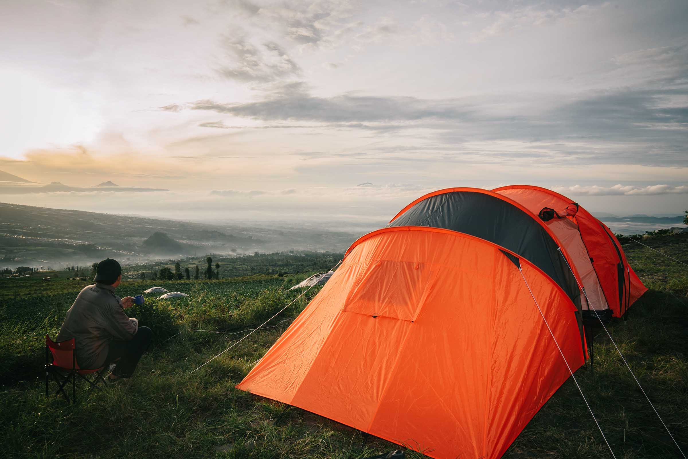 asian-man-camping-with-sunrise-view-in-mountain-po-23YZU9V.jpeg